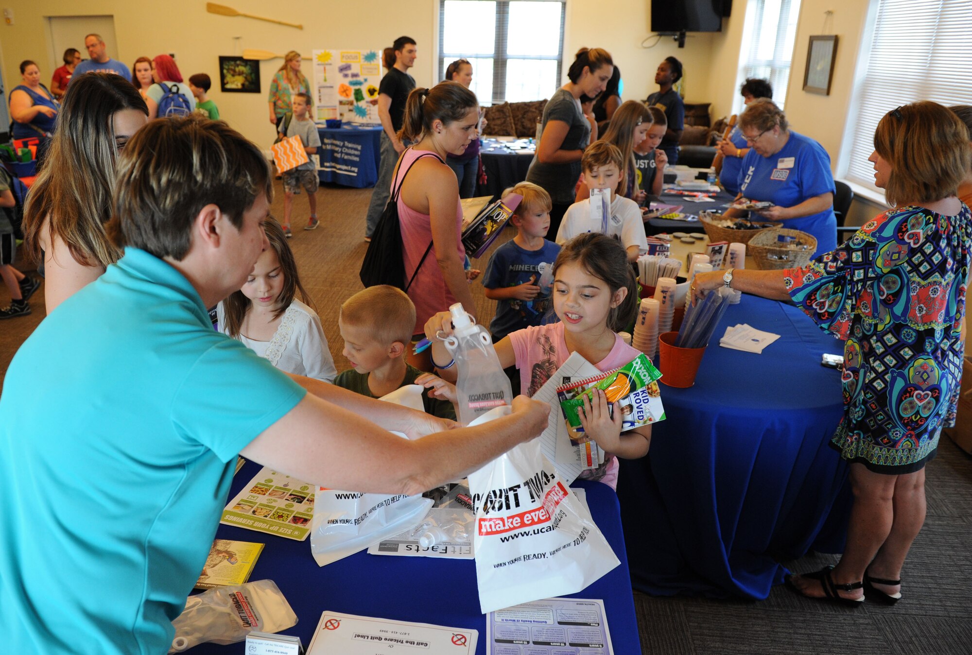 Military families gather at the Bay Ridge Community Center for a back-to-school event sponsored by Operation Homefront July 2, 2016, on Keesler Air Force Base, Miss. The event provided military families with backpacks and school supplies. (U.S. Air Force photo by Kemberly Groue/Released)