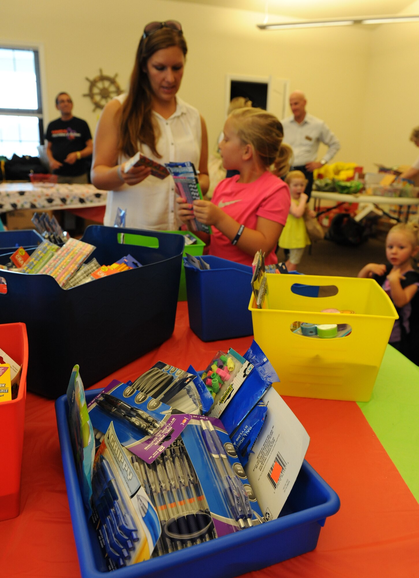 Diane Ledbetter and her daughter, Abigail, gather assorted school supplies at the Bay Ridge Community Center during a back-to-school event sponsored by Operation Homefront July 2, 2016, on Keesler Air Force Base, Miss. The event provided military families with backpacks and school supplies. (U.S. Air Force photo by Kemberly Groue/Released)