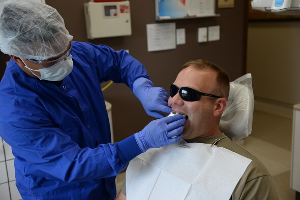Staff Sgt. Nathaniel Farinas, 14th Medical Operations Squadron Dental Technician, fits a tray of fluoride into a patient’s mouth July 29 at Columbus Air Force Base, Mississippi. Prevention techniques reduce the chance for dental injuries and increase readiness. (U.S. Air Force photo/Airman 1st Class John Day)