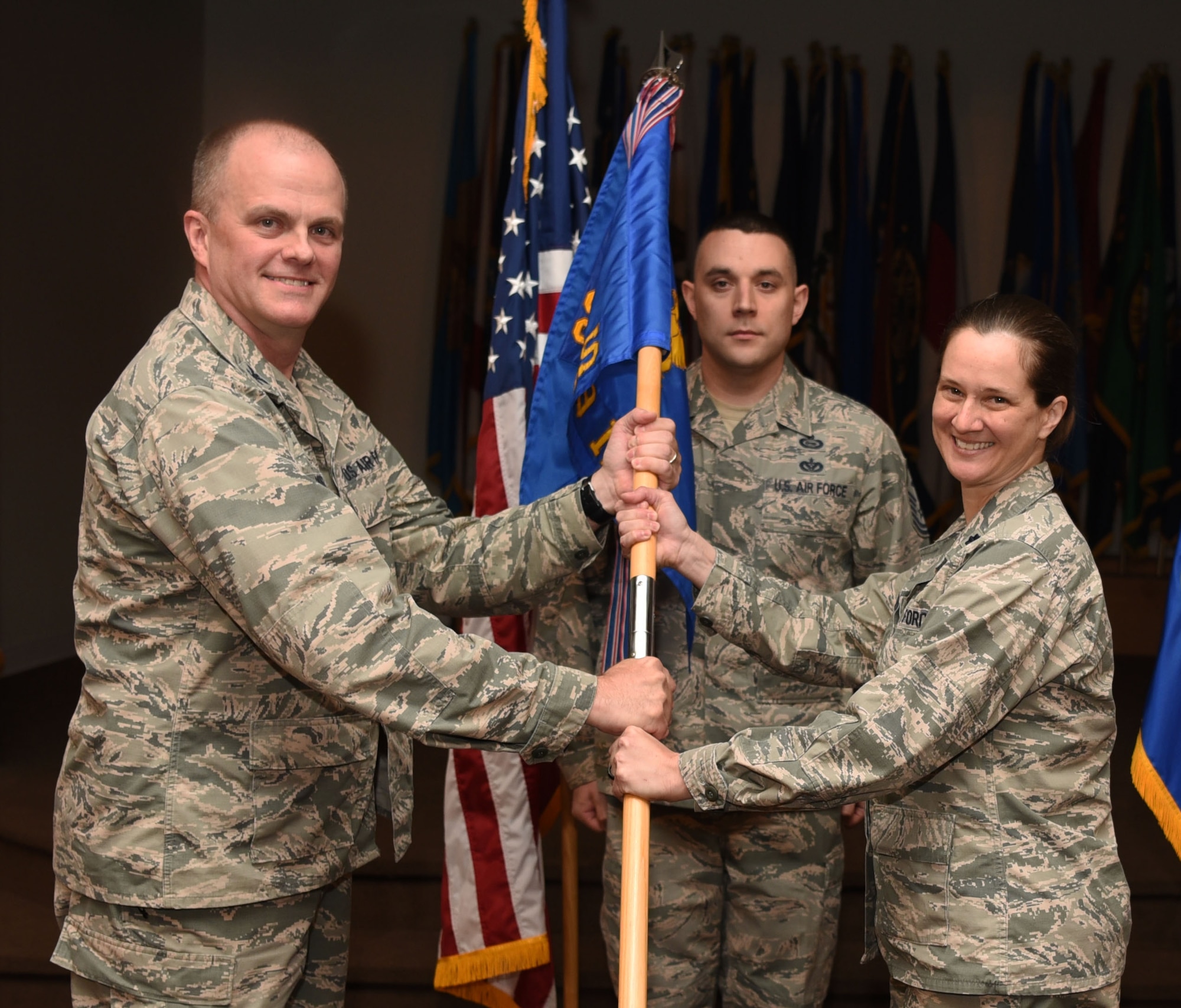 Col. Todd Sauls, 90th Operations Group commander, passes the guidon to Lt. Col. Tory Kindrick, 319th Missile Squadron commander, during the 319th MS change-of-command ceremony Aug. 5, 2016, at F.E. Warren Air Force Base, Wyo. The ceremony signified the transition of command from Lt. Col. Jeremy Olson to Lt. Col. Kindrick. (U.S. Air Force photo by Airman 1st Class Breanna Carter)

