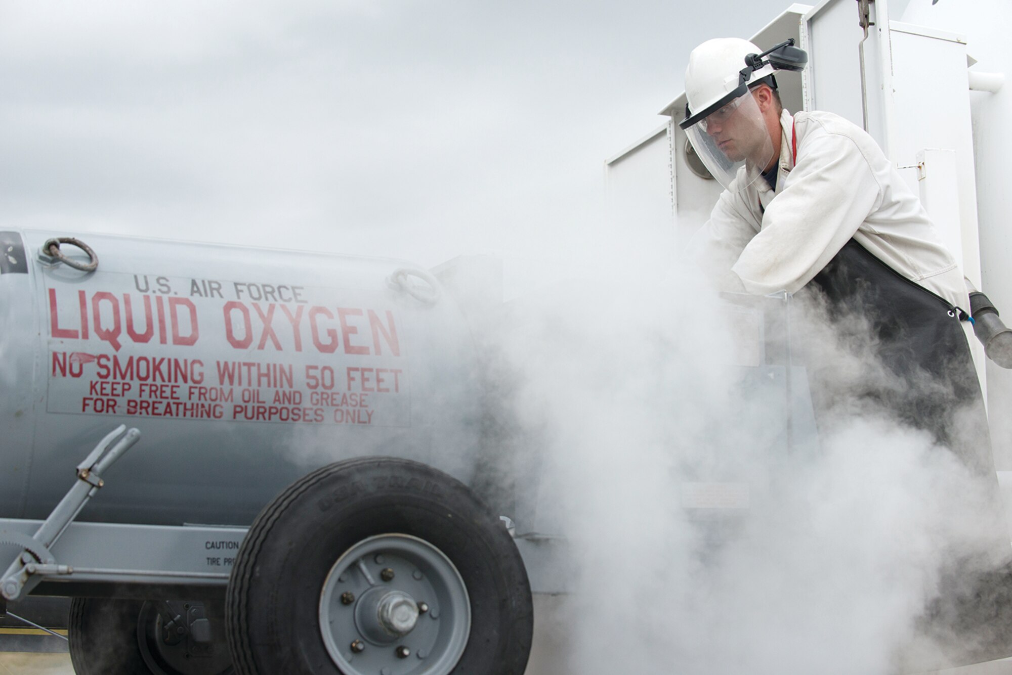 Senior Airman Levi Roark, 673d Logistics Readiness Squadron, fuels distribution journeyman refills an oxygen tank outside the Joint Base Elmendorf-Richardson, Alaska flightline, July 22. The tanks are picked up by Aircrew Ground Equipment Airmen when they are empty and then delivered back out to the jets after they've been filled. 