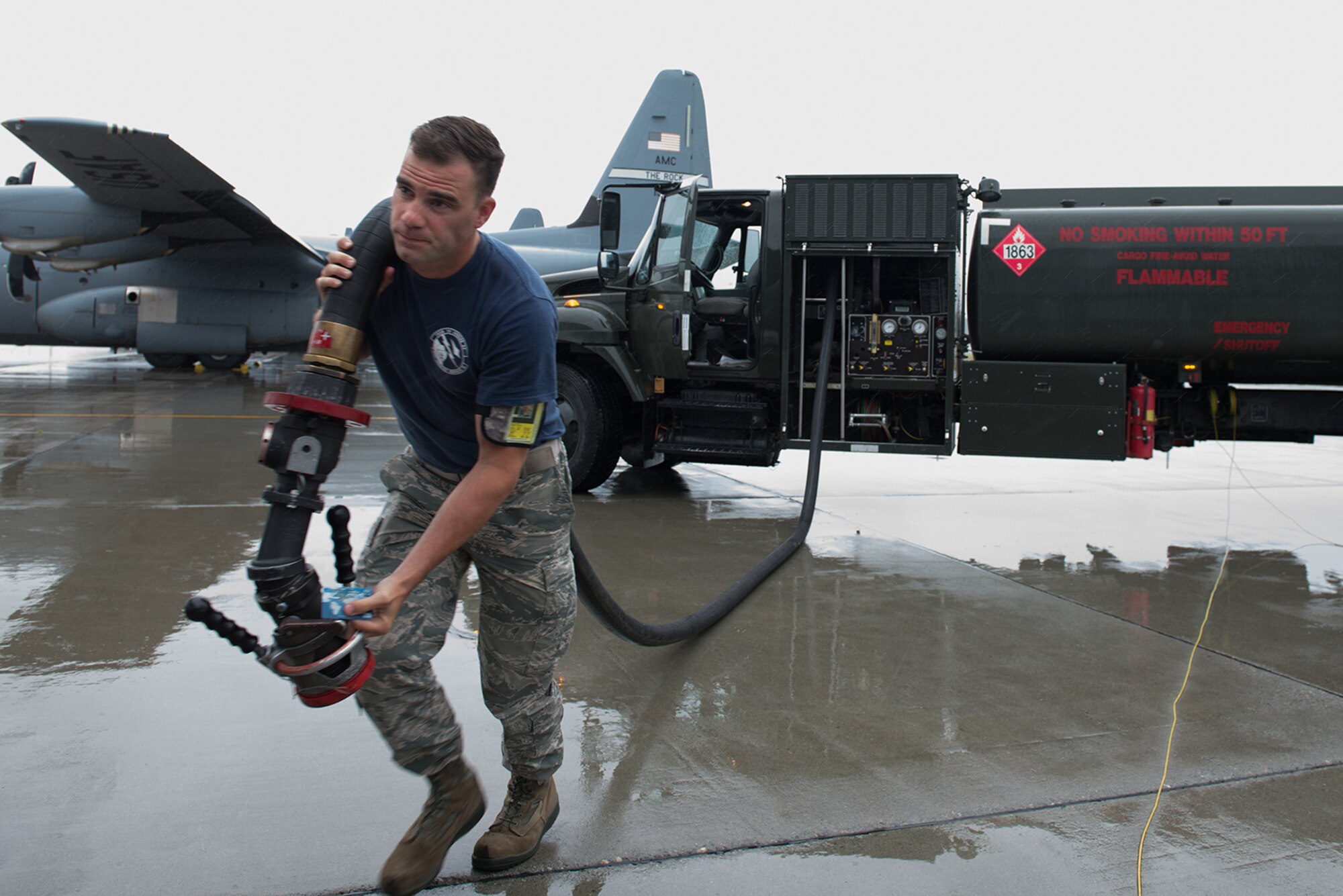 Senior Airman Levi Roark, 673d Logistics Readiness Squadron, fuels distribution journeyman pulls a hose out to a C-17 Globemaster III on the Joint Base Elmendorf-Richardson flightline July 22. Rain or shine, aircraft need fuel.