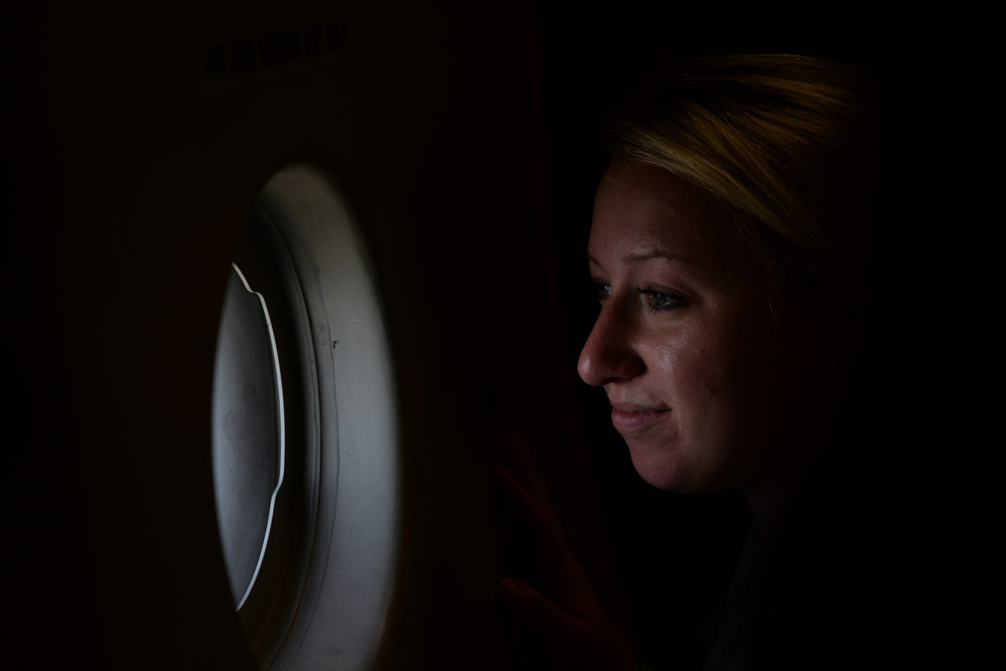 Senior Airman Jessica Jarosz, 81st Dental Squadron dental assistant, looks out a window on a C-17 Globemaster III during an incentive flight Aug. 4, 2016, at Keesler Air Force Base, Miss. The incentive flight was part of a weeklong hurricane exercise to prepare Keesler for the current hurricane season. (Air Force Photo by Airman 1st Class Travis Beihl/Released)