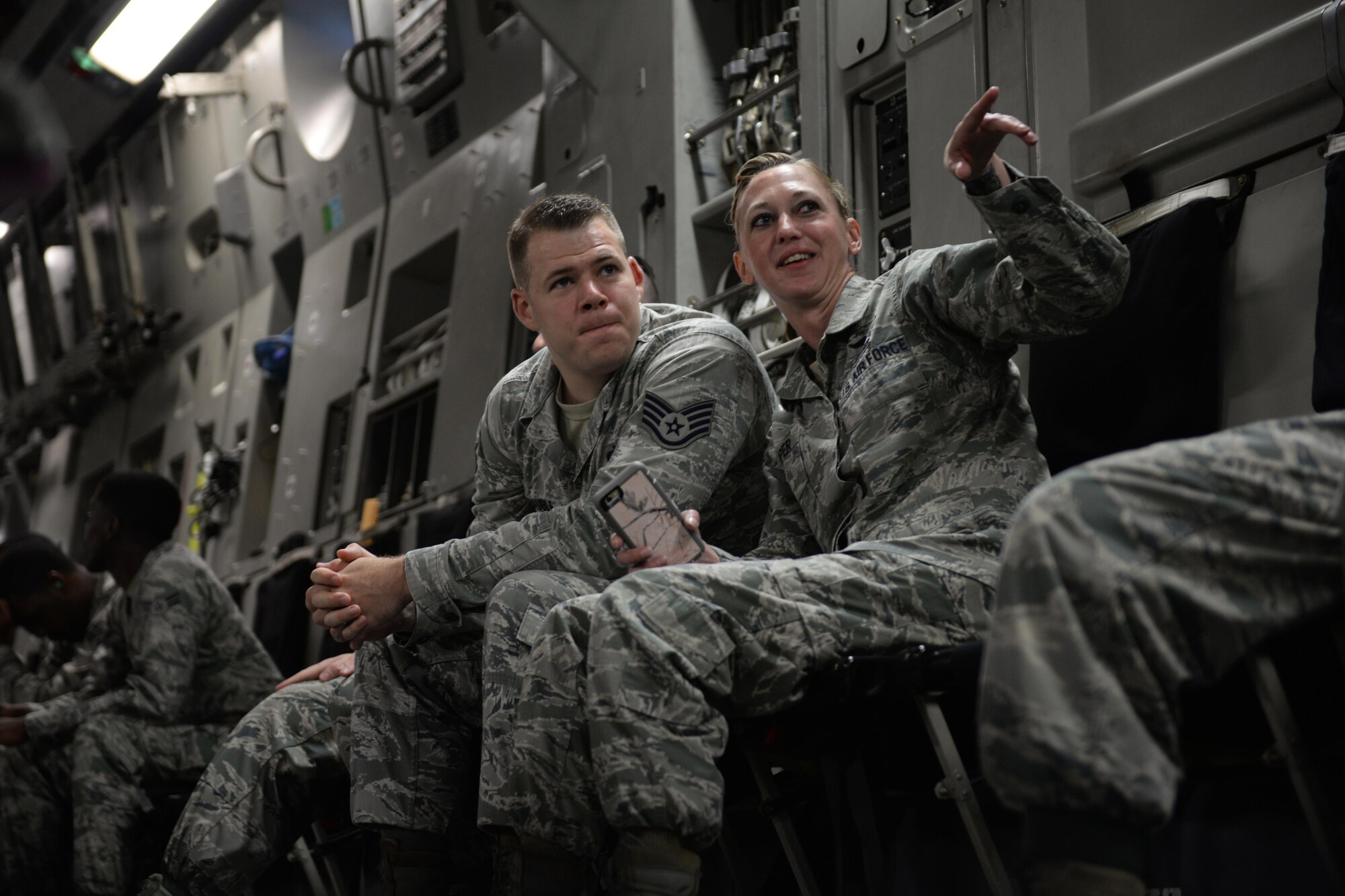 Staff Sgt. Craig Schauble, 334th Training Squadron air traffic control instructor, and Tech. Sgt. Jennifer Harper, 81st Training Wing equal opportunity specialist, share a conversation during an incentive flight Aug. 4, 2016, at Keesler Air Force Base, Miss. The incentive flight was part of a weeklong hurricane exercise to prepare Keesler for the current hurricane season. (Air Force Photo by Airman 1st Class Travis Beihl/Released)