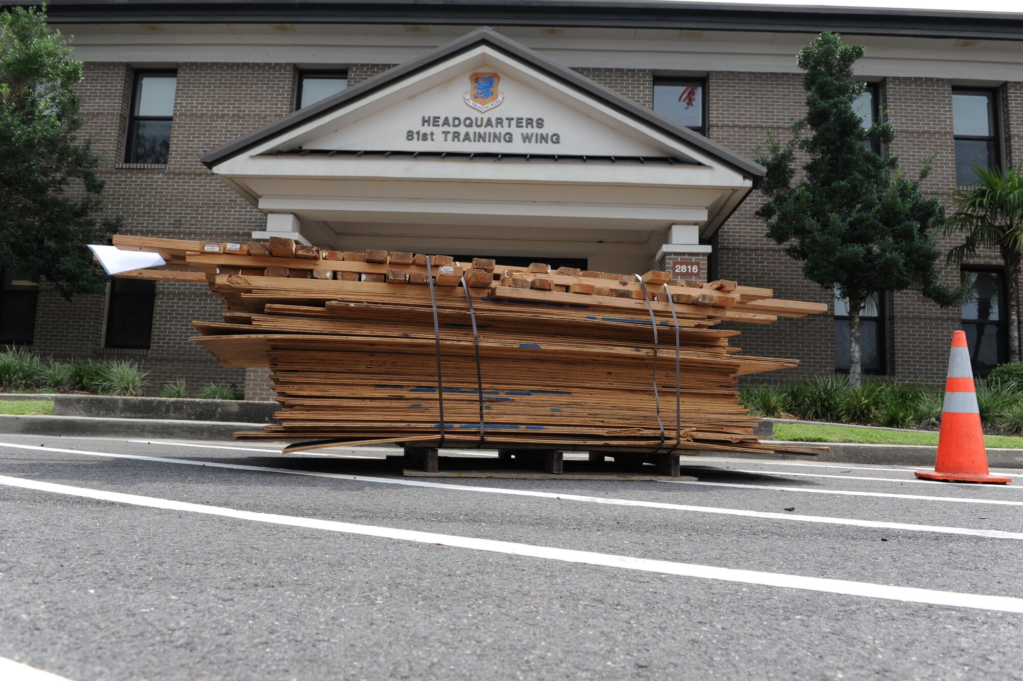 A pallet of boarding materials are placed in front of the 81st Training Wing headquarters building for securing doors and windows during a hurricane exercise Aug. 3, 2016, on Keesler Air Force Base, Miss. The purpose of the exercise was to prepare Keesler for the current hurricane season. (U.S. Air Force photo by Kemberly Groue/Released)