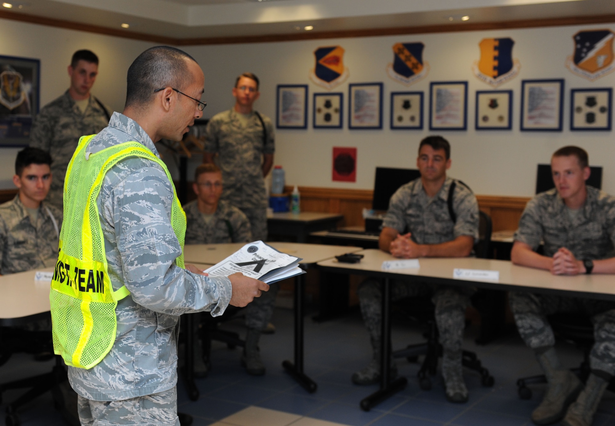Capt. Santiago Camacho, 335th Training Squadron director of operations and shelter management team member, brief non-prior service Airmen on hurricane shelter in-processing procedures at Allee Hall during a hurricane exercise Aug. 5, 2016, on Keesler Air Force Base, Miss. The purpose of the exercise was to prepare Keesler for the current hurricane season. (U.S. Air Force photo by Kemberly Groue/Released)