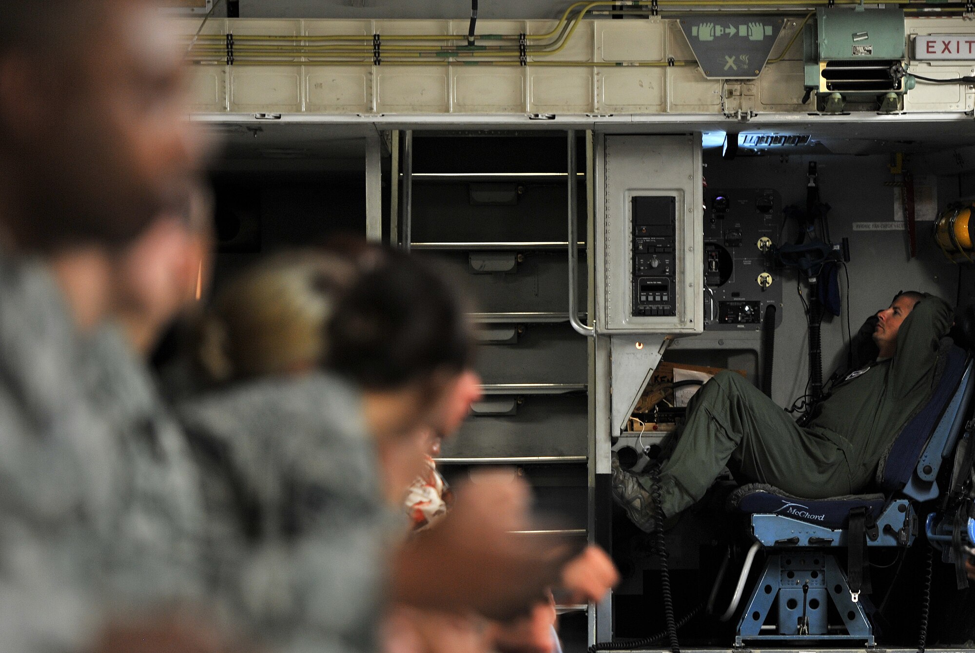 Tech. Sgt. Jack Metzger, 97th Training Squadron C-17A evaluator loadmaster, relaxes following takeoff during an incentive flight for Airmen and civilians assigned to Keesler Air Force Base, Miss., Aug. 4, 2016. The incentive flight was part of a weeklong hurricane exercise to prepare Keesler for the current hurricane season. (U.S. Air Force photo by Senior Airman Duncan McElroy/Released)