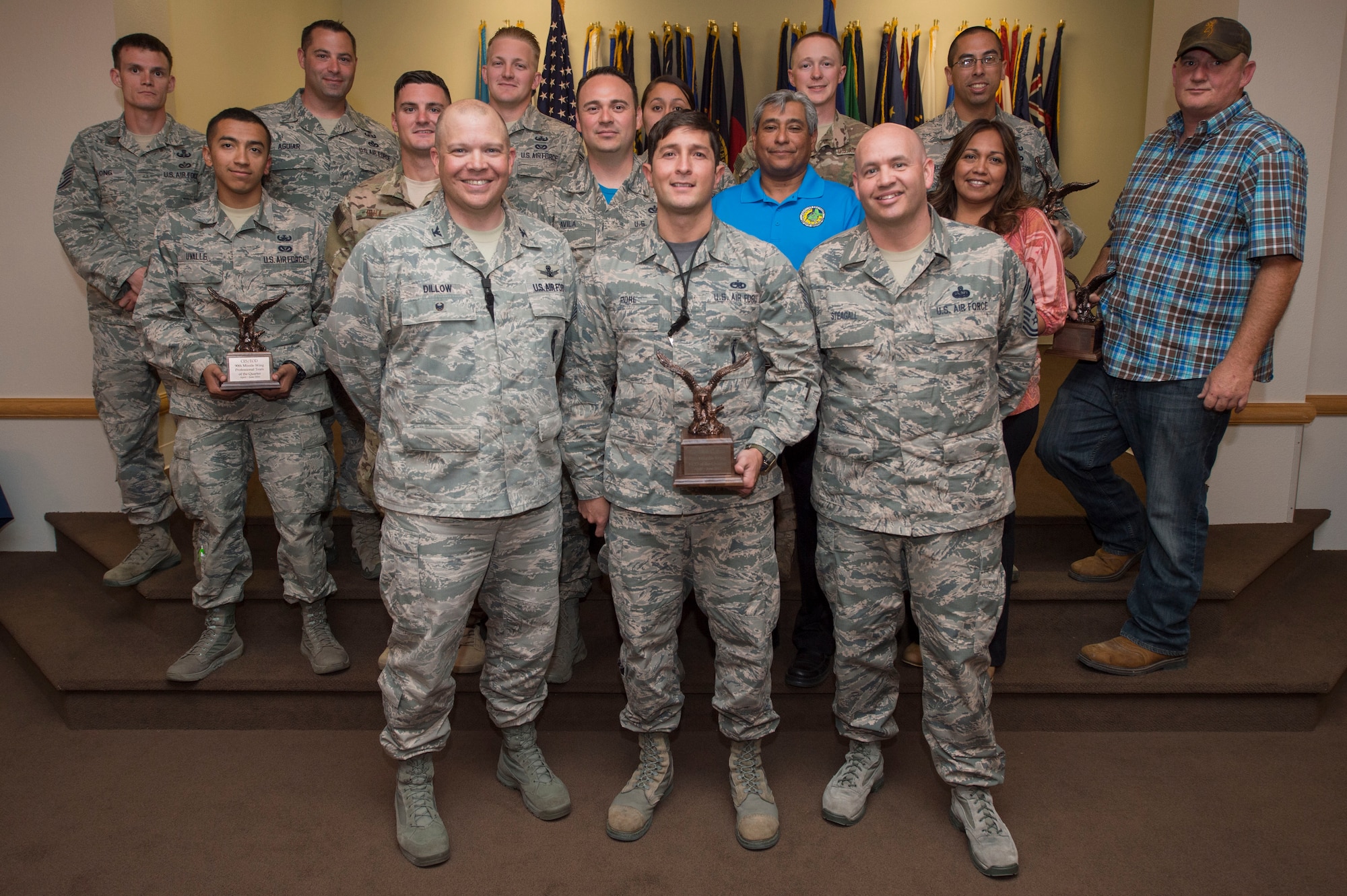 Col. Matt Dillow, 90th Missile Wing vice commander, and Chief Master Sgt. Jeffery Steagall, 90th MW command chief, pose with the wing’s second quarter award winners Aug. 5, 2016, at F.E. Warren Air Force Base, Wyo. The wing holds a ceremony each quarter for all the nominees and presents awards to the winners. (U.S. Air Force photo by Staff Sgt. Christopher Ruano)