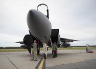 U.S. Air Force Airmen 1st Class Jordan Baker and Timothy Rich, both assigned to the 336th Aircraft Maintenance Unit, Seymour Johnson Air Force Base, N.C., remove a cover from a U.S. Air Force F-15E Strike Eagle fighter aircraft Aug. 5, 2016, at Eielson Air Force Base, Alaska, prior to the familiarization day of RED FLAG-Alaska 16-3. This exercise provides unique opportunities to integrate various forces into joint, coalition and multilateral training from simulated forward operating bases. (U.S. Air Force photo by Staff Sgt. Shawn Nickel)