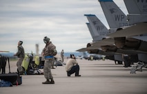 U.S. Air Force Airmen assigned to the 8th Aircraft Maintenance Squadron, Kunsan Air Base, Republic of South Korea, show excitement while preparing an F-16 Fighting Falcon aircraft for take off Aug. 5, 2016, at Eielson Air Force Base, Alaska, during the familiarization day of RED FLAG-Alaska (RF-A) 16-3. RF-A simulates the first 10 combat sorties of an initial surge during a conflict, enabling pilots to better understand the stresses of the environment. (U.S. Air Force photo by Staff Sgt. Shawn Nickel)