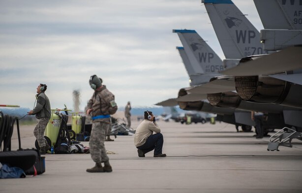 U.S. Air Force Airmen assigned to the 8th Aircraft Maintenance Squadron, Kunsan Air Base, Republic of South Korea, show excitement while preparing an F-16 Fighting Falcon aircraft for take off Aug. 5, 2016, at Eielson Air Force Base, Alaska, during the familiarization day of RED FLAG-Alaska (RF-A) 16-3. RF-A simulates the first 10 combat sorties of an initial surge during a conflict, enabling pilots to better understand the stresses of the environment. (U.S. Air Force photo by Staff Sgt. Shawn Nickel)