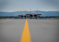 U.S. Air Force F-15E Strike Eagles dual-role fighter aircraft assigned to the 336th Fighter Squadron, Seymour Johnson Air Force Base, N.C., taxi for take off Aug. 5, 2016, at Eielson Air Force Base, Alaska, during familiarization day of RED FLAG-Alaska 16-3. This exercise provides unique opportunities to integrate various forces into joint, coalition and multilateral training from simulated forward operating bases. (U.S. Air Force photo by Staff Sgt. Shawn Nickel)