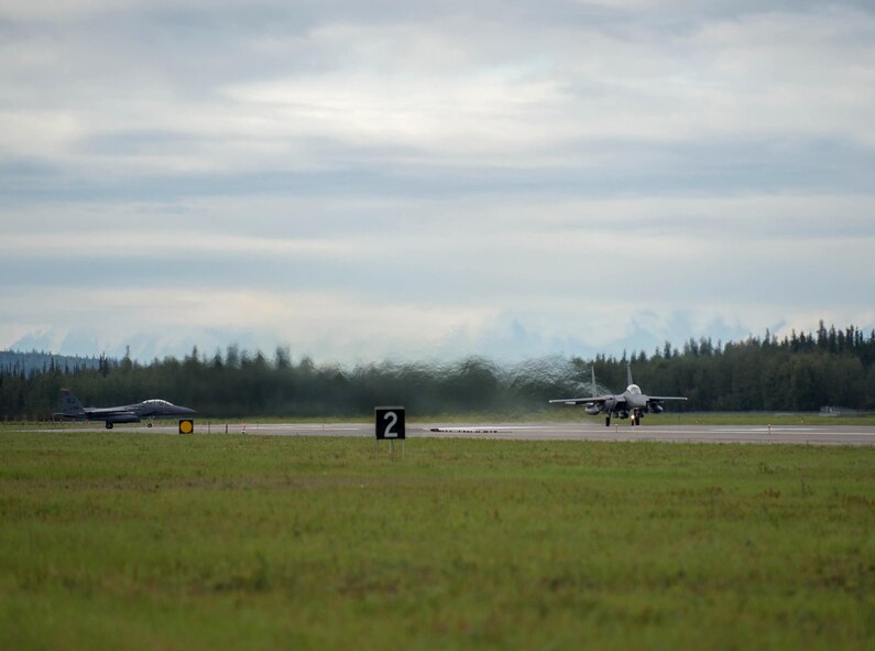 U.S. Air Force F-15E Strike Eagle dual-role fighter aircraft assigned to the 336th Fighter Squadron, Seymour Johnson Air Force Base, N.C., take off Aug. 5, 2016, at Eielson Air Force Base, Alaska, during familiarization day of RED FLAG-Alaska (RF-A) 16-3. Originally operated under the name COPE THUNDER, the exercise moved to Eielson in 1992 from Clark Air Base, Philippines, after the eruption of Mount Pinatubo on June 15, 1991. COPE THUNDER was re-designated RF-A in 2006. (U.S. Air Force photo by Staff Sgt. Shawn Nickel)