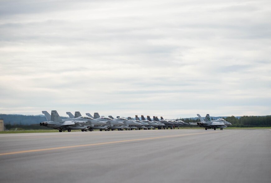U.S. Air Force F-15E Strike Eagle dual-role fighter aircraft assigned to the 336th Fighter Squadron, Seymour Johnson Air Force Base, N.C., U.S. Navy EA-18G Growler aircraft assigned to the Electronic Attack Squadron 135, Naval Air Station Whidbey Island, Wash., and Royal Canadian Air Force CF-18 Hornet fighter aircraft assigned to the 409th Tactical Fighter Squadron, Canadian Forces Base Cold Lake, Canada, line up at the end of runway Aug. 5, 2016, at Eielson Air Force Base, Alaska, during familiarization day of RED FLAG-Alaska (RF-A) 16-3. Free exchange of ideas between multilateral forces during RF-A enhances not just partners and sister service relationships, but also their operational efficiency. (U.S. Air Force photo by Staff Sgt. Shawn Nickel)