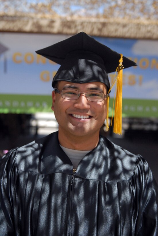 Air Force Tech. Sgt. Jason Balolong received his associate's degree in Construction Technology from the Community College of the Air Force during a graduation ceremony May 28, 2013, at Kandahar Airfield, Afghanistan. Balolong was among 55 service members and civilians to receive degrees from among 14 universities during the ceremony. Staff Sgt. Jessica Villaverde, not pictured, also received her degree from CCAF. (U.S. Army photo by Staff Sgt. Scott Tynes, 102nd Mobile Public Affairs Detachment)