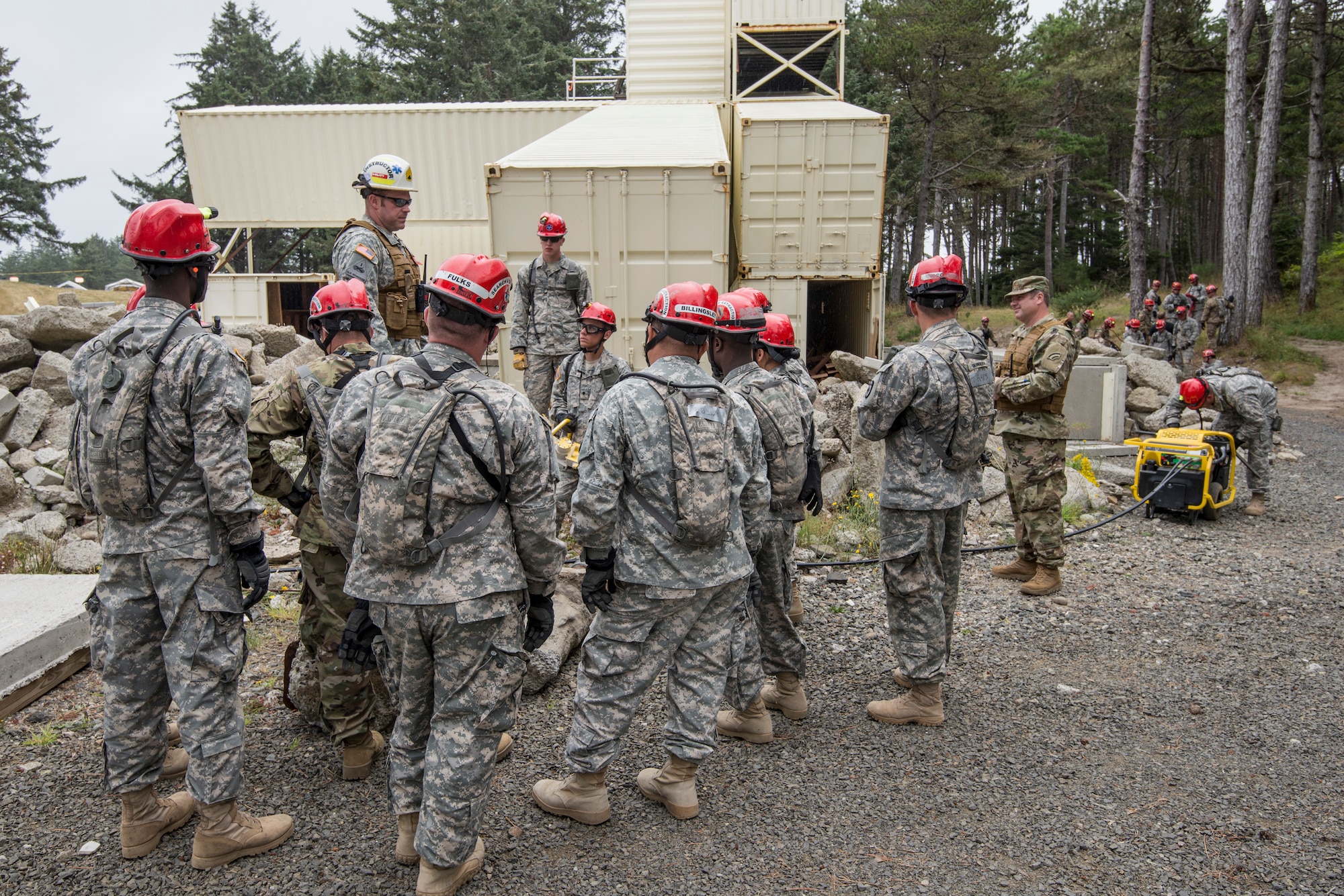 U.S. Colorado National Guard Airmen and Soldiers, assigned to the search and extraction teams (SNE) listen to an evaluator explain procedures for cutting through piles of cement rubble with a chain saw, after a simulated chemical attack, during a joint exercise evaluation (EXEVAL) at Camp Rilea in Warrenton, Oregon, on Aug.2, 2016. The Soldiers and Airmen will practice search and extraction techniques to save lives in the event of a domestic emergency. (U.S. Air National Guard photo by Staff Sgt. Bobbie Reynolds) 