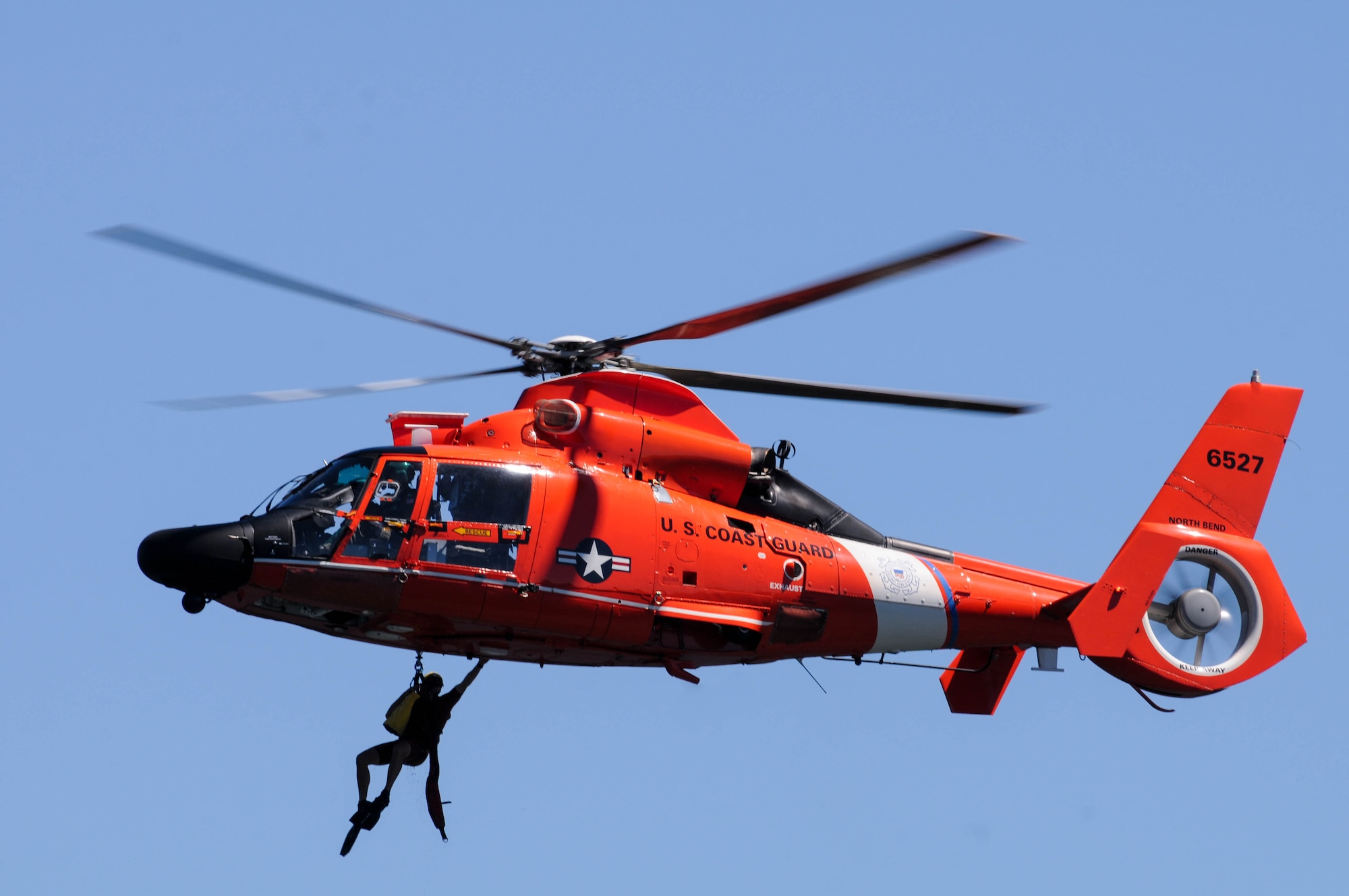 U.S. Coast Guard Aviation Survival Technician 3rd Class Brendan Davis, Coast Guard Sector North Bend, ascends for extraction via helicopter during water survival training at Lake of the Woods near Klamath Falls, Ore., July 22, 2016. Aircrew Flight Equipment members joined with Klamath County Sheriff's Department agencies and members of Coast Guard Sector North Bend to provide Kingsley’s F-15 pilots water survival training in the event of an emergency ejection. (U.S. Air National Guard photo by Staff Sgt. Penny Snoozy)