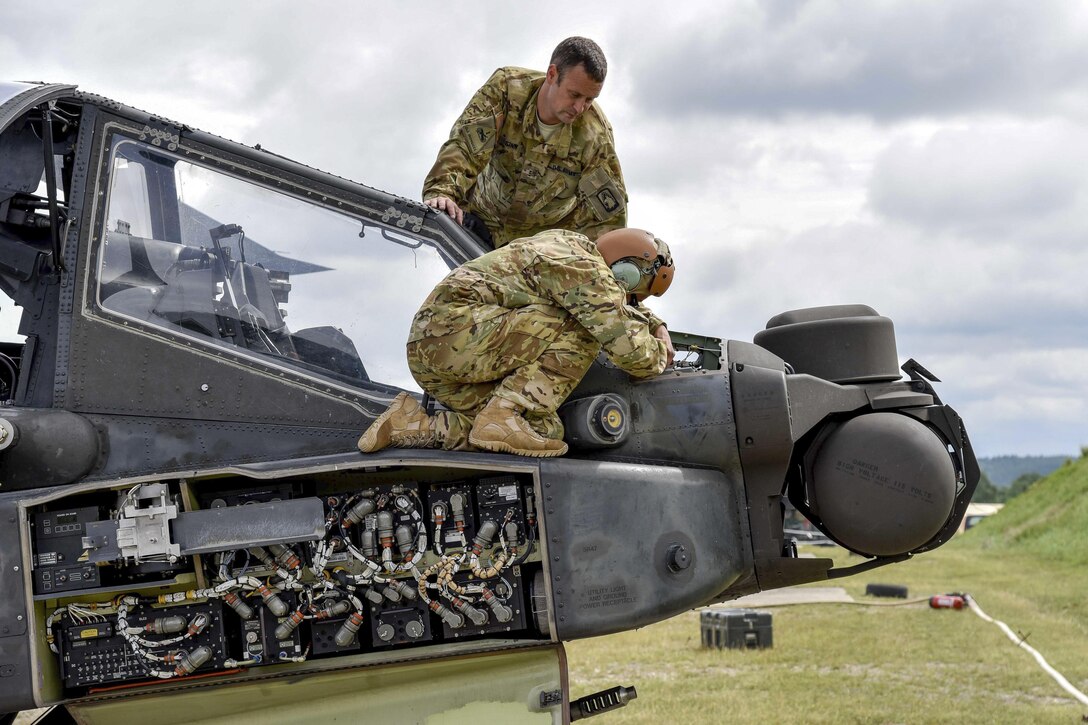 Soldiers conduct preventive maintenance checks on an AH-64D Apache Longbow helicopter during training at the Grafenwoehr Training Area in Germany, Aug. 3, 2016. Army photo by Spc. Nathanael Mercado