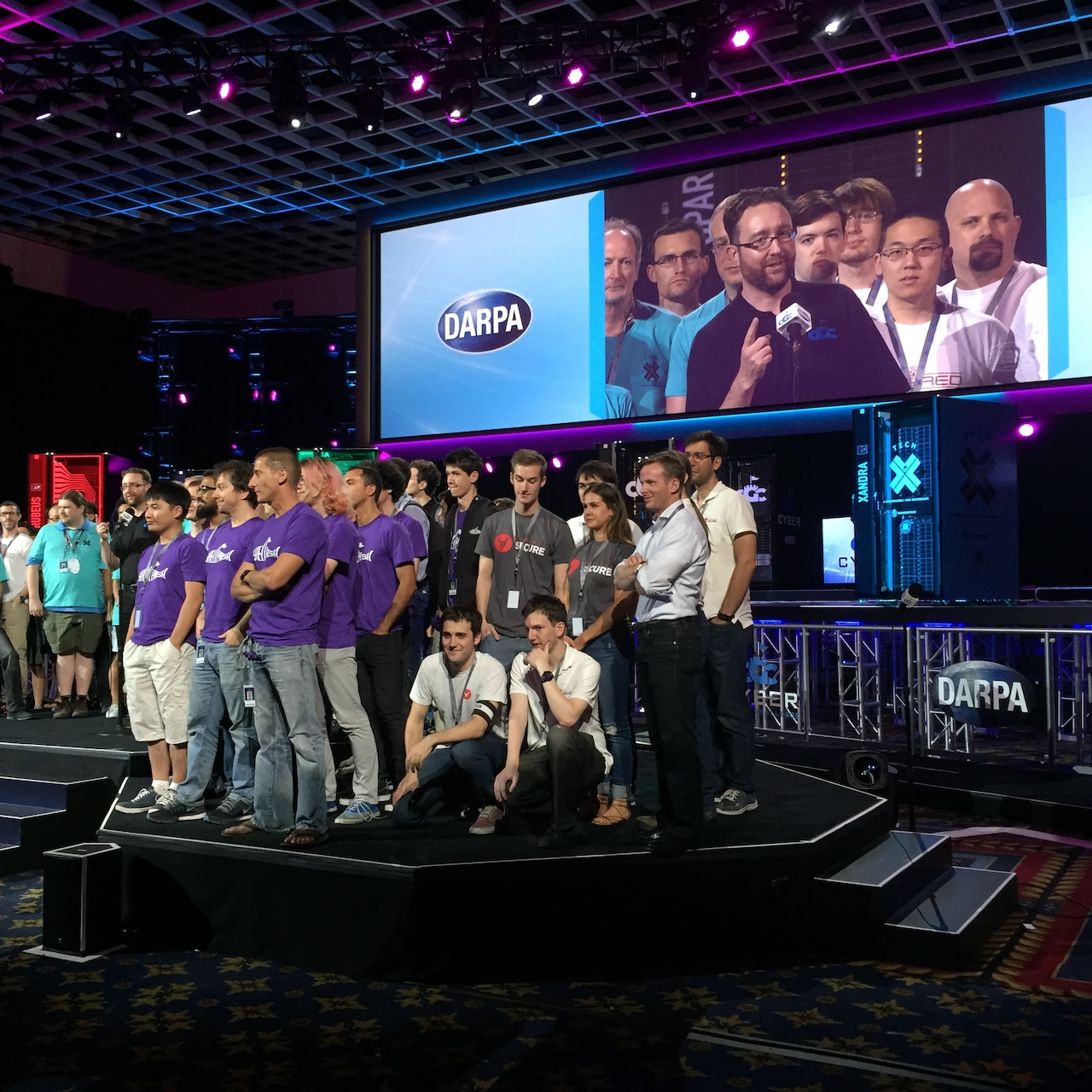 DARPA Program Manager Mike Walker gathers all the finalist teams on stage Aug. 4 in Las Vegas at the end of the DARPA Cyber Grand Challenge, the world’s first all-machine hacking tournament. DoD photo by Cheryl Pellerin