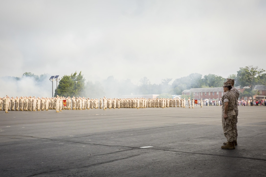 Commandant of the Marine Corps General Robert B. Neller and Col. Julie L. Nethercot stand at attention as the graduates of Officer Candidate Class 222 render honors to Neller during an Officer Candidates School graduation ceremony aboard Marine Corps Base Quantico, Va., Aug. 6, 2016. Candidates who graduated with OCC-222 were apart of the largest OCS graduating class since 2009. Nethercot is the commanding officer of OCS. Neller was the observing officer for the ceremony.