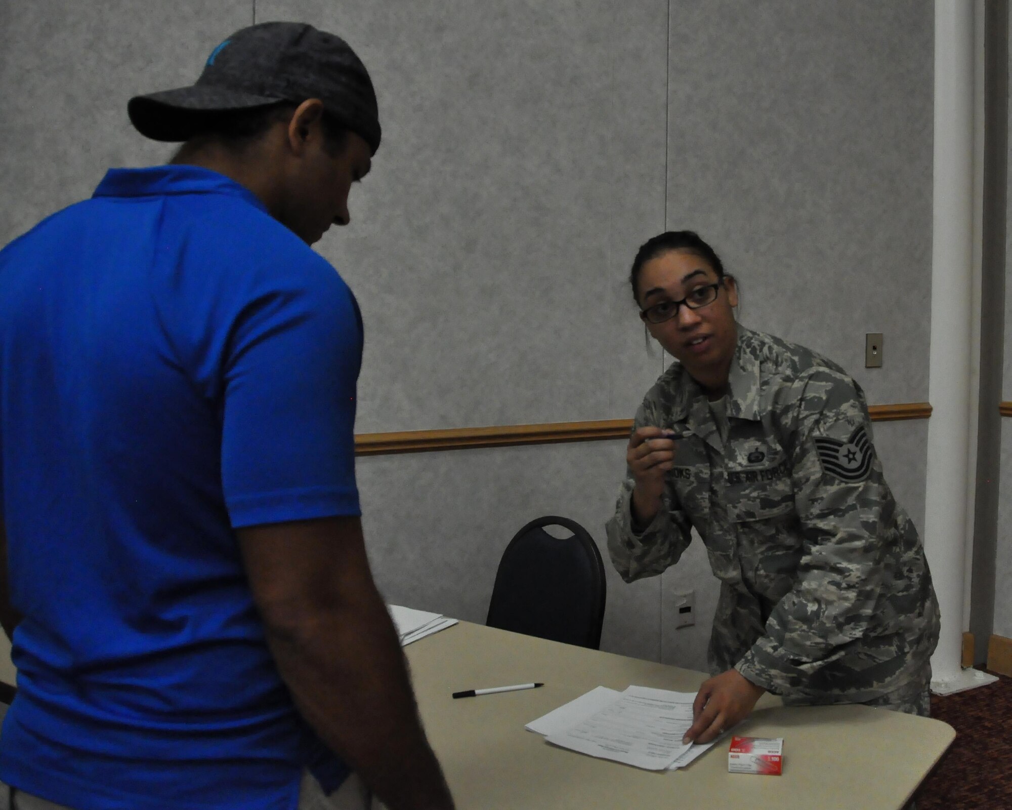 Tech. Sgt. Angelique Brooks, 931st Force Support Squadron NCO in charge of customer support, directs an individual ready reserve member for more information during an IRR muster Aug. 6, 2016, McConnell AFB, Kansas. Each year IRR Airmen report in to update their personal information and receive updates on service-related benefits. (U.S. Air Force Photo by Senior Airman Preston Webb)
