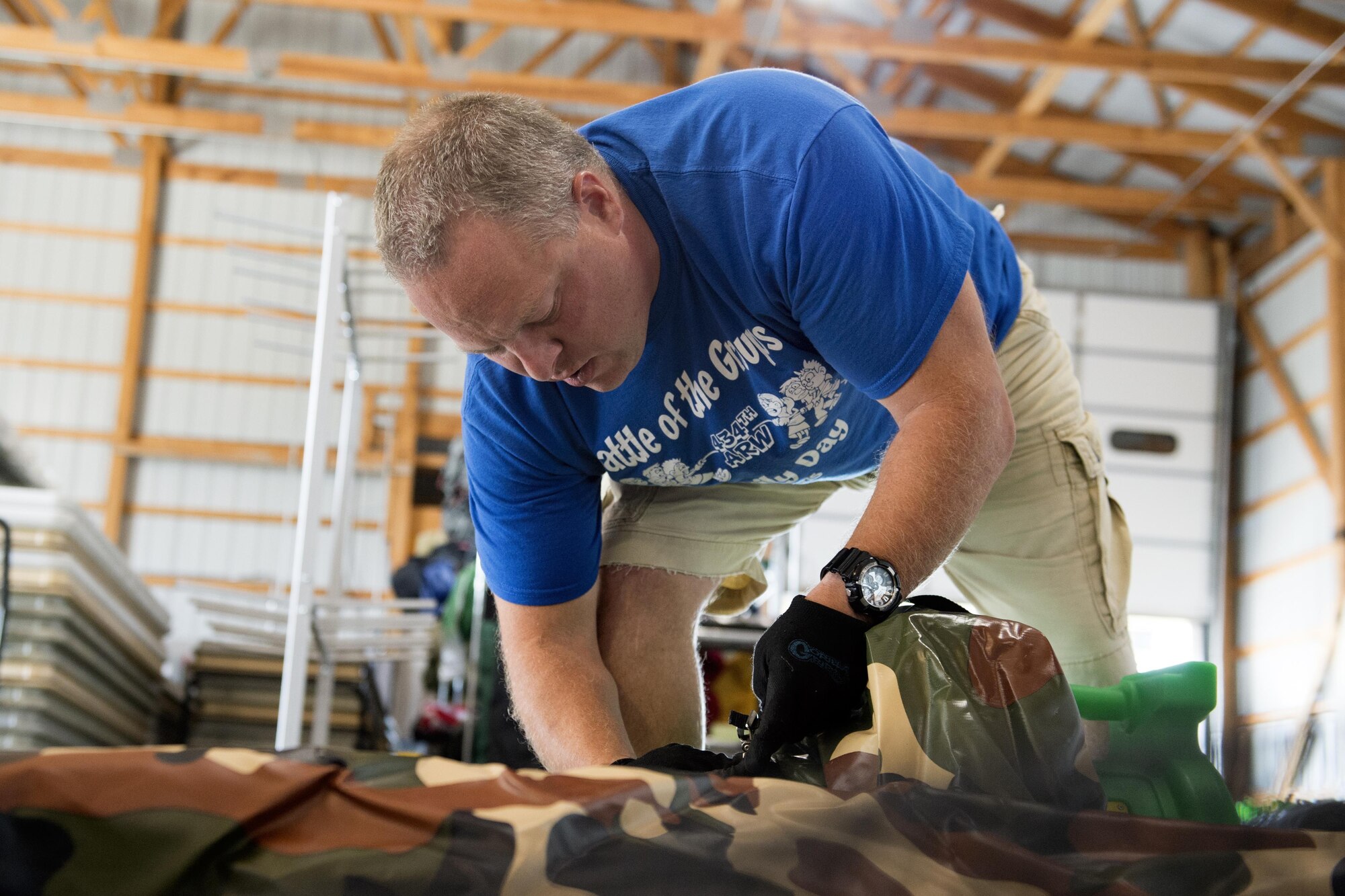 Tom Bellamy, 434th Services Flight outdoor activities recreation specialist, attaches an inflatable bouncer to an air pump to check for leaks and cleanliness prior to it being rented to a customer at Grissom Air Reserve Base, Ind., August 5, 2016. Bellamy was recently promoted to the new position, and strives to bring awareness to it. (U.S. Air Force photo/Tech. Sgt. Benjamin Mota)