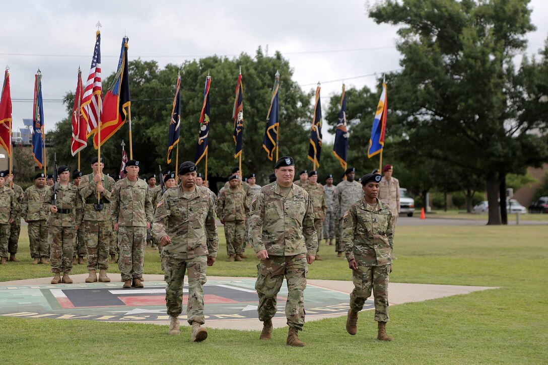 Left to Right: Command Sgt. Maj. Jeffrey Moses, outgoing command sergeant major; Col. Brian Payne, Brigade Commander, 120th Infantry Brigade; and Command Sgt. Maj. Cheryl Greene, Command Sergeant Major, 120th Infantry Brigade walk off the parade field after a Change of Responsibility ceremony at Fort Hood, Texas on July 26, 2016. The ceremony marked the passing of responsibility from Moses to Greene. 
(Photo by Mr. Anthony L. Taylor)