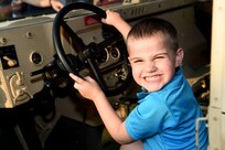 Jasper, 4, laughs while sitting in a Humvee during Arlington Heights National Night Out on Aug. 2, 2016. When asked what he thought of the Army Jasper gave two thumbs up. National Night Out is a police event conducted across the U.S. and Canada on the second Tuesday of every August. 
(Photo by Sgt. Aaron Berogan)