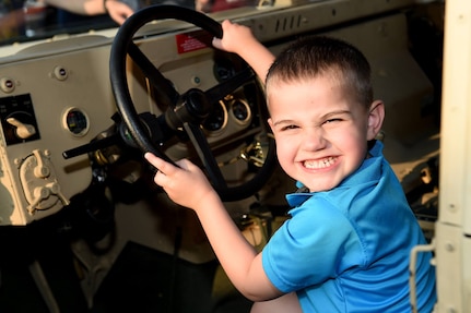 Jasper, 4, laughs while sitting in a Humvee during Arlington Heights National Night Out on Aug. 2, 2016. When asked what he thought of the Army Jasper gave two thumbs up. National Night Out is a police event conducted across the U.S. and Canada on the second Tuesday of every August. 
(Photo by Sgt. Aaron Berogan)