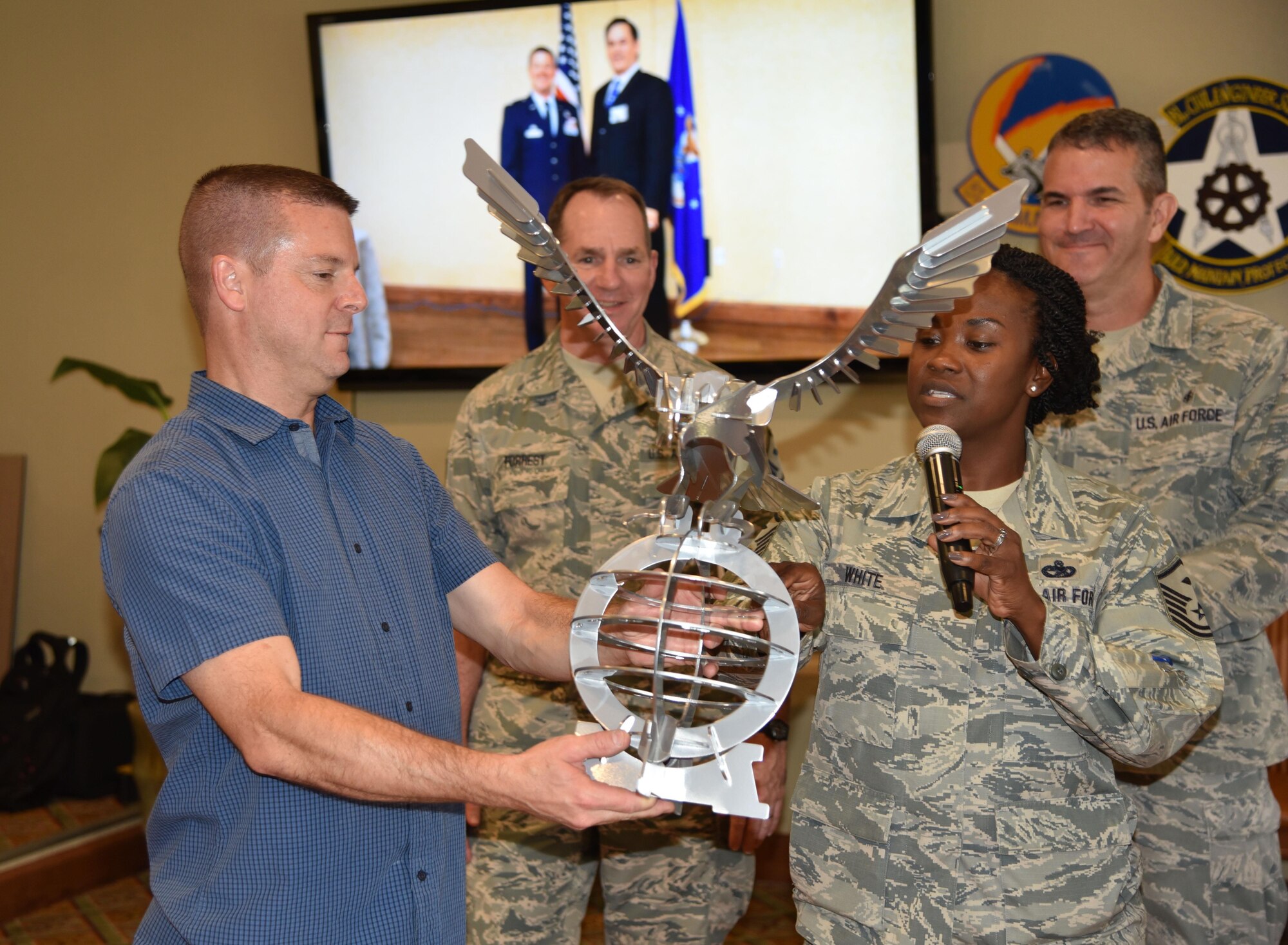 On behalf of the 403rd Wing First Sergeants Council, Master Sgt. Demetrice White, 403rd Logistics Readiness Squadron first sergeant, presents Col. Frank L. Amodeo, 403rd Wing commander, with an eagle at his farewell reception, Aug. 6, 2016. Amodeo is scheduled to take command of the 927th Air Refueling Wing, MacDill Air Force Base, Florida, Sept. 11, 2016. (U.S. Air Force photo/Maj. Marnee A.C. Losurdo)