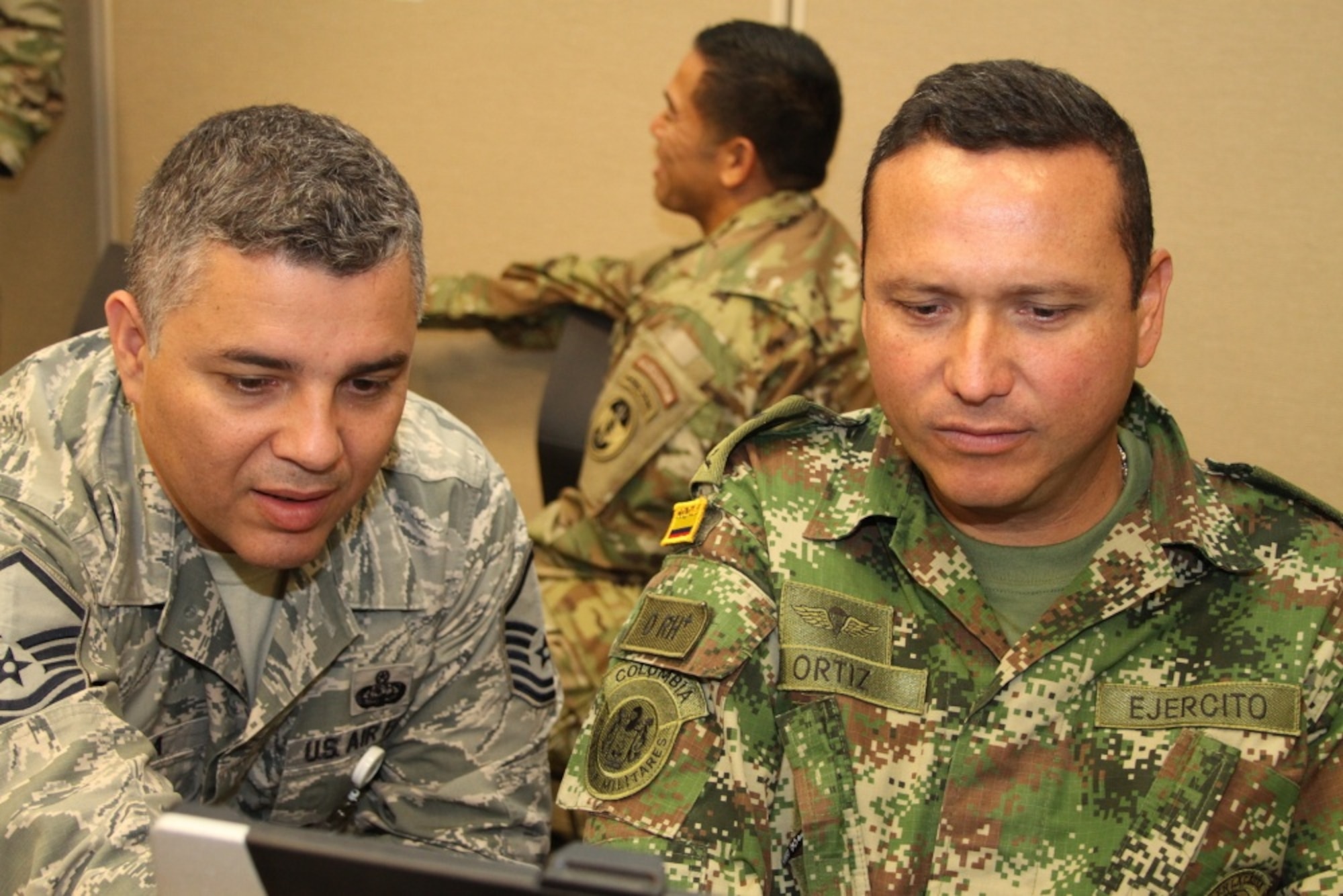 Colombian army Lt. Col. Oscar Ortiz collaborate during the annual military exercise Panamax 16 at Special Operations Command South, Homestead, Fla., July 29, 2016. Panamax 16 is a U.S. Southern Command sponsored exercise with an overall objective of increasing interoperability among participating Nations (U.S. Army photo by Capt. Daisy Bueno)