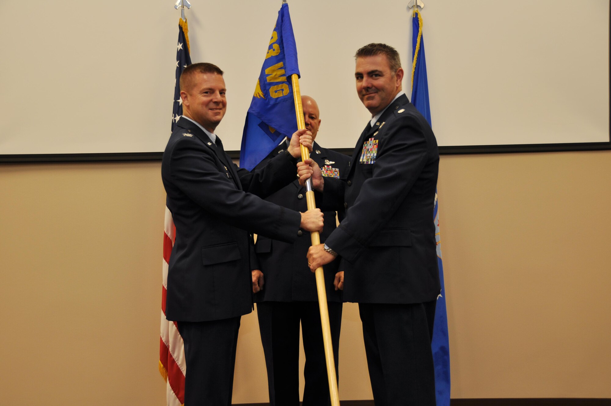 Col. Frank L. Amodeo, 403rd Wing commander, passes the 403rd Operations Group guidon to Lt. Col. Brian A. May during a ceremony at Keesler Air Force Base, Mississippi, Aug. 6, 2016. (U.S. Air Force photo/Master Sgt. Jessica L. Kendziorek)