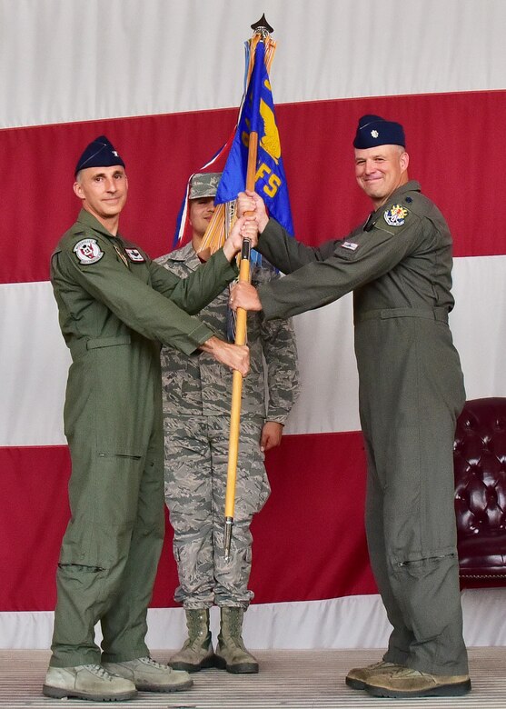 Col. Robert Tofil, 944th Operations Group commander, hands the 69th Fighter Squadron guidon to Lt. Col. Sean Rassas, the new 69 FS commander, Aug 5 during a change-of -command ceremony held at Luke Air Force Base, Ariz. (U.S. Air Force photo by Tech. Sgt. Louis Vega Jr.)