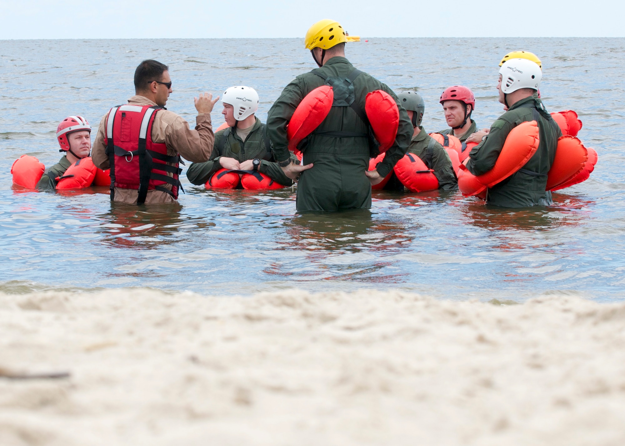Tech. Sgt. Joseph Monreal, 436th Operations Support Squadron, instructs water survival training to Airmen with the 436th and 512th Airlift Wings Aug. 5, 2016, at Bowers Beach, Del. The Airmen worked on treading water, raft survival and rescue via helicopter basket. (U.S. Air Force Photo/ Staff Sgt. Tiffany Lindemann)