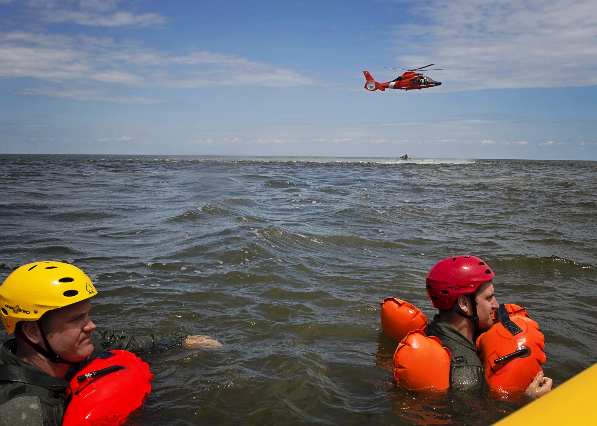 Capt. Eric Steen (left), 3rd Airlift Squadron pilot, and Capt. Paul Deadman, 709th Airlift Squadron pilot, tread water while waiting to practice helicopter extraction during water survival training, Aug. 5, 2016, Bower’s Beach Del. The Airmen worked on treading water, raft survival and rescue via helicopter basket during the training. (U.S. Air Force Photo/ Tech. Sgt. Nathan Rivard)