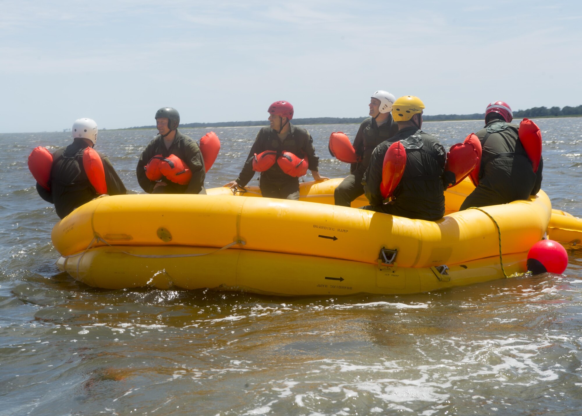 Airmen with the 512th and 436th Airlift Wings wait for helicopter extraction during a water survival course, Aug. 5, 2016, Bowers Beach, Del. The refresher-training course must be completed every three years. (U.S. Air Force Photo/ Tech. Sgt. Nathan Rivard)