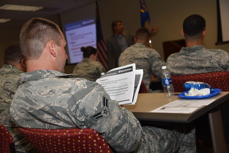 An Airman glances at a financial empowerment packet during a presentation from Bank United at MacDill Air Force Base, FL on Aug 7, 2016. Bank United visited the base as a part to share tips on budgeting, good credit building practices, paying-off debts and planning for the future. (U.S. Air Force photo by Senior Airman Xavier Lockley)