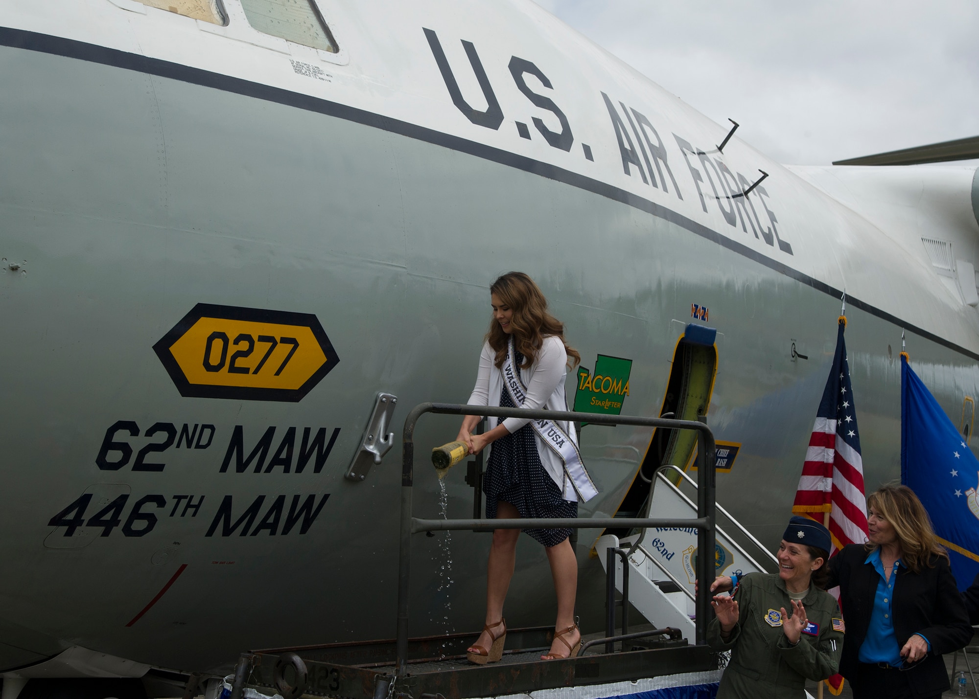 Kelsey Schmidt, Miss Washington 2016, rechristens the C-141 Starlifter, serial number 65-0277, August 6, 2016, at Heritage Hill, Joint Base Lewis-McChord, while Lt. Col. Elizabeth Scott, commander 4th Airlift Squadron, and Sandra Marth Hill, Miss Washington 1966, look on. In honor of the first C-141 arrival at McChord, members of the 62nd and 446th Airlift Wings celebrated with museum volunteers, veterans, and community members for the 50th anniversary of the arrival of McChord's first C-141. (Air Force Reserve photo by Tech. Sgt. Bryan Hull)