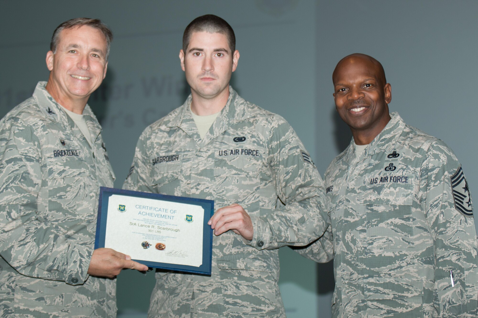 Senior Airman Lance Scarbrough, 301st Logistics Readiness Squadron, receives the 2016 Airman of the Quarter award Aug. 6 during a wing commander's call here. Scarbrough was recognized for his outstanding leadership, job performance, self-improvement and community involvement during the first quarter of the calendar year. (U.S. Air Force photo by Master Sgt. Josh Woods)