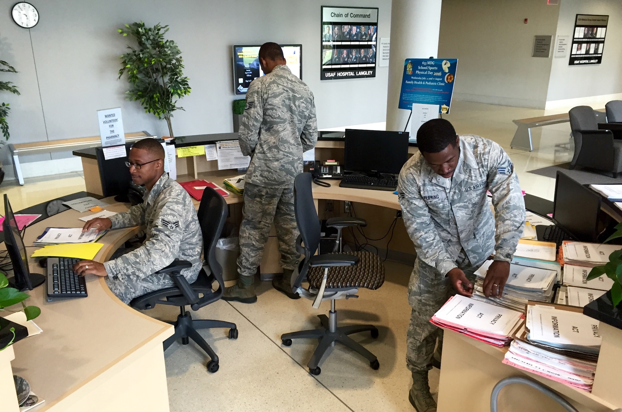 Senior Airman Christopher Casey (left), Staff Sgt. Torrey Miller (center), and Senior Airman Calvin Fleming prepare for patients at the Joint Base Langley-Eustis, Va., clinic Aug. 6, 2016. The Airmen are health services management technicians for the 920th Aerospace Medicine Squadron, a geographically separated unit of the 920th Rescue Wing at Patrick Air Force Base, Fla. (U.S. Air Force photo by 1st Lt. Anna-Marie Wyant)