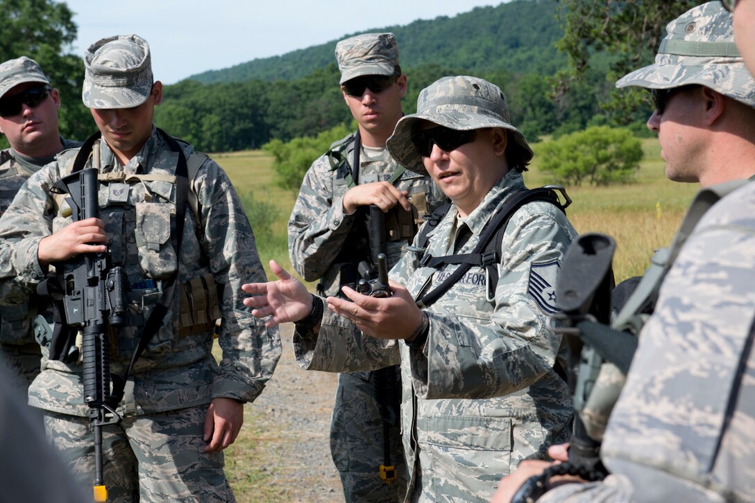 Master Sgt. Tammy Marks conducts a quick review of a training exercise with members of the 167th Security Forces Squadron during their field training event in Gerrardstown, W.Va., June 22. (U.S. Air National Guard photo by Senior Master Sgt. Emily Beightol-Deyerle)