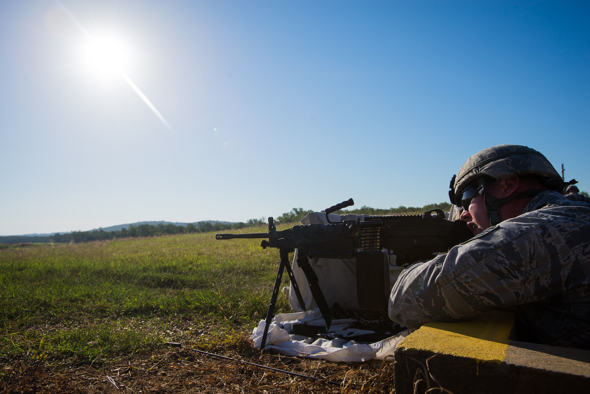 Staff Sgt. Phillip Courtney, 137th Security Forces Squadron Airman, fires an M249 during heavy weapons training at Camp Gruber Training Center near Braggs, Okla., Aug. 3, 2016.  Approximately 40 members of the 137 SFS completed annual training from July 29 to Aug, 5, 2016. Airmen participated in extensive training exercises including close combat, weapons, military operations on urban terrain and navigation. (U.S. Air National Guard photo by Senior Airman Tyler Woodward/Released)