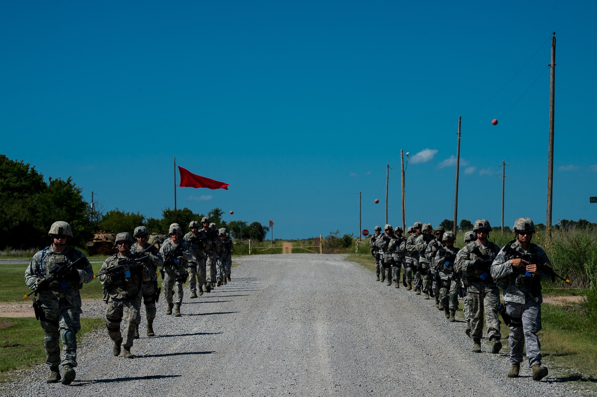Airmen with the 137th Security Forces Squadron walk in formation at Camp Gruber Training Center near Braggs, Okla., Aug. 3, 2016.  Approximately 40 members of the 137 SFS completed annual training from July 29 to Aug, 5, 2016. Airmen participated in extensive training exercises including close combat, weapons, military operations on urban terrain and navigation. (U.S. Air National Guard photo by Senior Airman Tyler Woodward/Released)