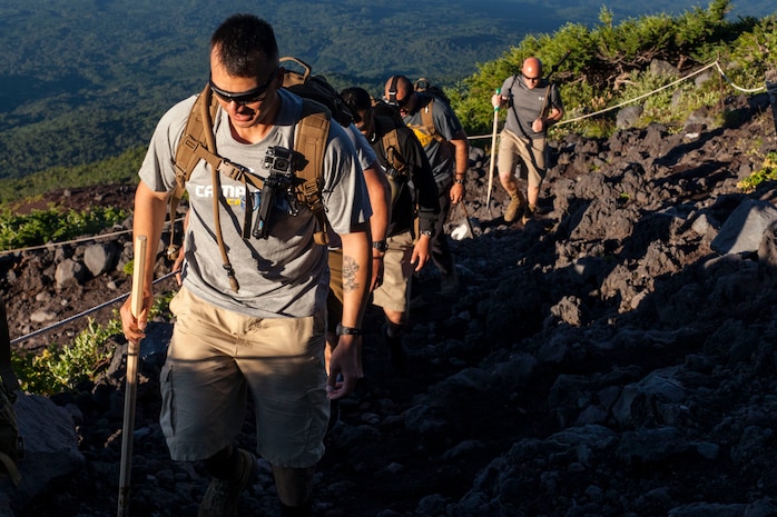 U.S. Marine Corps Staff Sgt. Scott Henryson, Headquarters and Service Company, company first sergeant, with Marine Wing Support Squadron (MWSS) 171, based out of Marine Corps Air Station Iwakuni, hikes up Mount Fuji, Japan, as part of a unit activity July 31, 2016. Marines within the squadron first conquered Mount Fuji with a 3,776 meter climb to the peak. Marines bought ‘Kongo-Tsue’ walking sticks and had stamps burned onto them, which signified the location and altitude throughout 10 stations located up the trail. (U.S. Marine Corps photo by Lance Cpl. Aaron Henson)