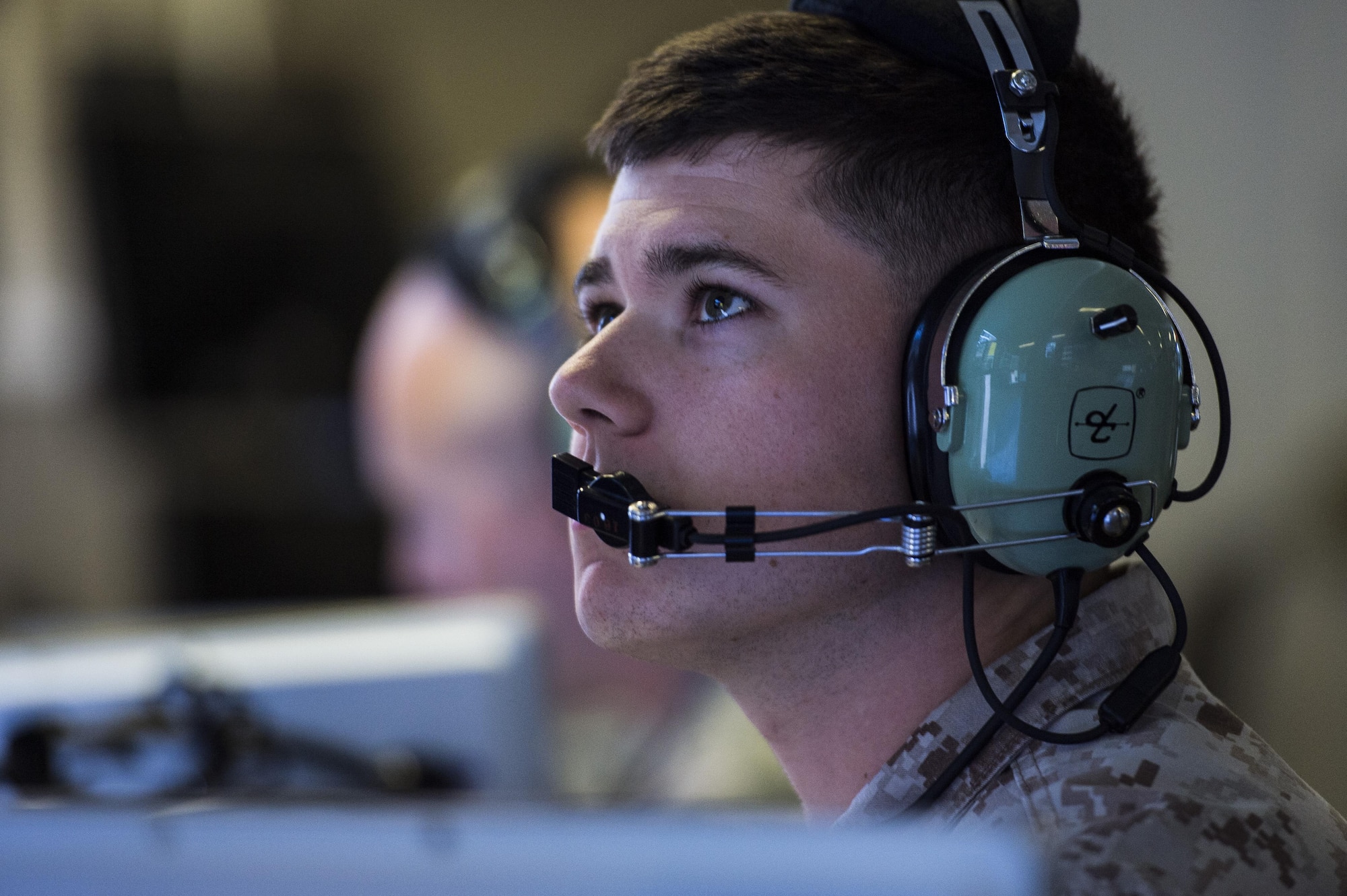 A U.S. Marine assigned to the 727th Expeditionary Air Control Squadron monitors his station in the Kingpin compound at an undisclosed location in Southwest Asia July 14, 2016. Kingpin is the persistent 24/7 command and control element in the CENTCOM area of responsibility which includes support of Operations INHERENT RESOLVE and RESOLUTE SUPPORT. (U.S. Air Force photo by Staff Sgt. Larry E. Reid Jr./released)
