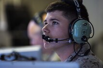A U.S. Marine assigned to the 727th Expeditionary Air Control Squadron monitors his station in the Kingpin compound at an undisclosed location in Southwest Asia July 14, 2016. Kingpin is the persistent 24/7 command and control element in the CENTCOM area of responsibility which includes support of Operations INHERENT RESOLVE and RESOLUTE SUPPORT. (U.S. Air Force photo by Staff Sgt. Larry E. Reid Jr./released)
