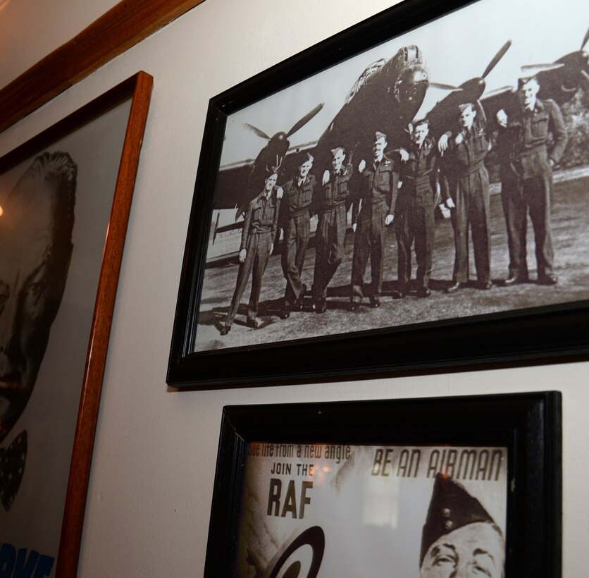 Photographs and posters hang on the walls in Middleton Hall Aug. 4, 2016, on RAF Mildenhall, England. The building was completed in 1931 and has seen many Airmen pass through its doors over the years. (U.S. Air Force photo by Gina Randall)