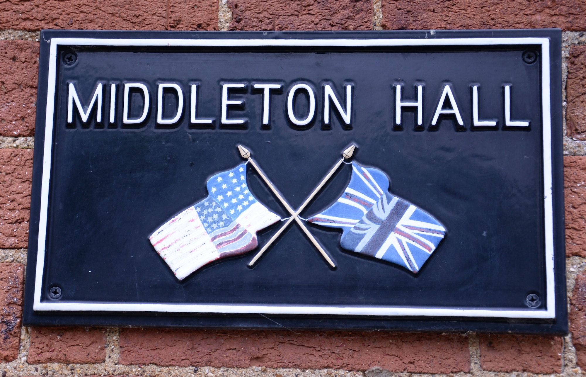 A building plaque is displayed outside Middleton Hall Aug. 4, 2016, on RAF Mildenhall, England. The building is used for many community relations events celebrating the tie between Americans and British. (U.S. Air Force photo by Gina Randall)