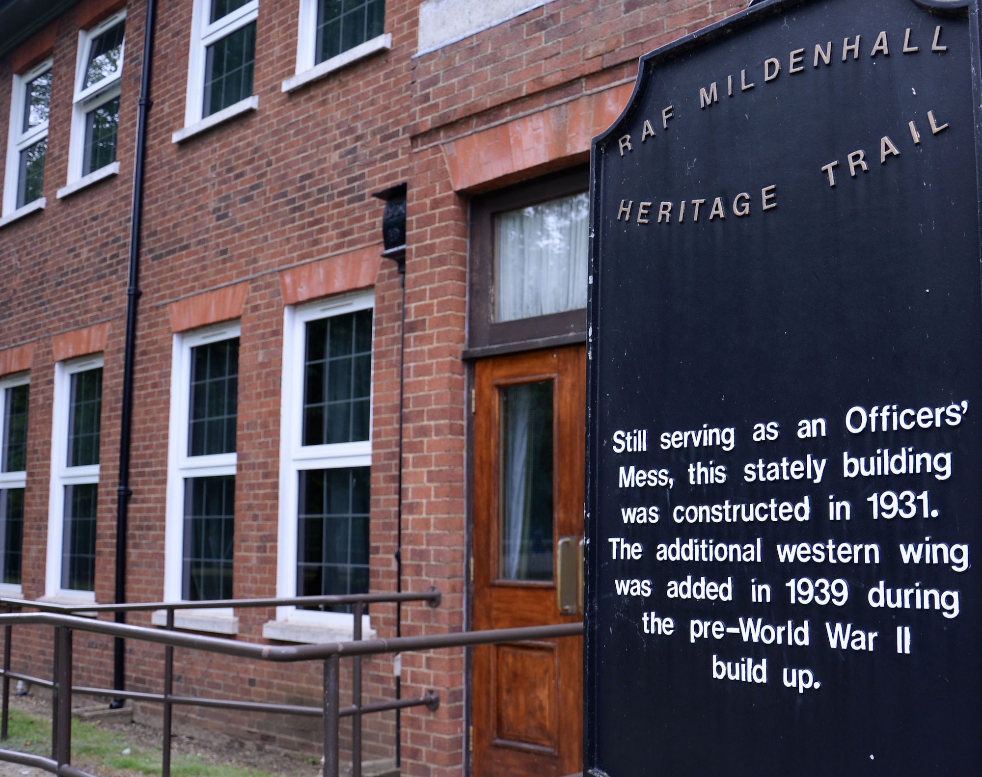 A heritage trail sign stands outside Middleton Hall Aug. 4, 2016, on RAF Mildenhall, England. In 1931 contractors completed the first buildings on base, including what is known today as Middleton Hall. (U.S. Air Force photo by Gina Randall)