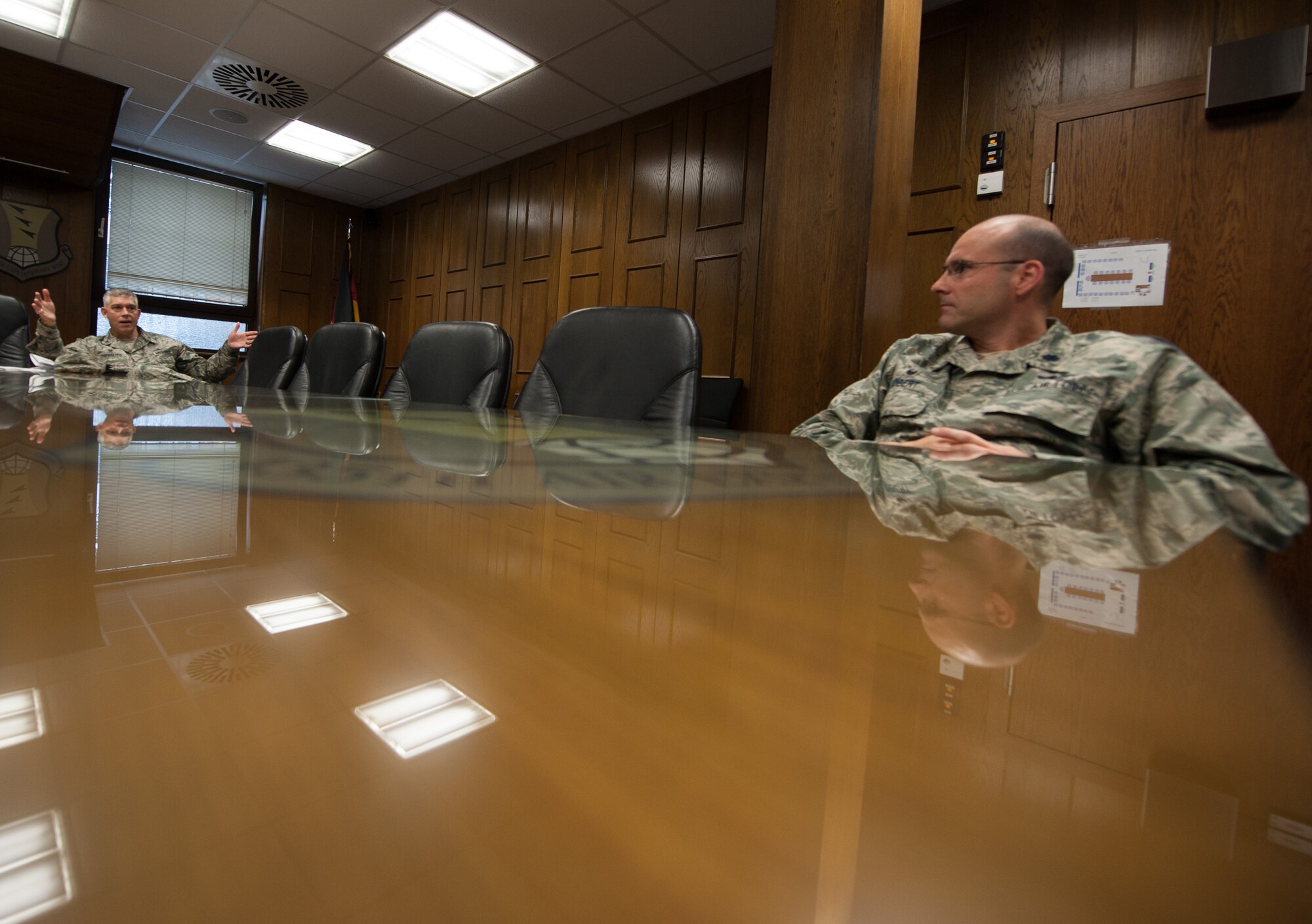 Col. Andrew D’Ippolito, 435th Air and Space Communications Group commander, talks with Lt. Col. Richard Obert, 435th Contingency Response Squadron commander, during a 435th Air Ground Operations Wing Inspector General briefing Aug. 4, 2016, at Ramstein Air Base, Germany. The briefings teach commanders the role of IG in how they assist in running their units more efficiently and safely. (U.S. Air force photo/Airman 1st Class Lane T. Plummer)